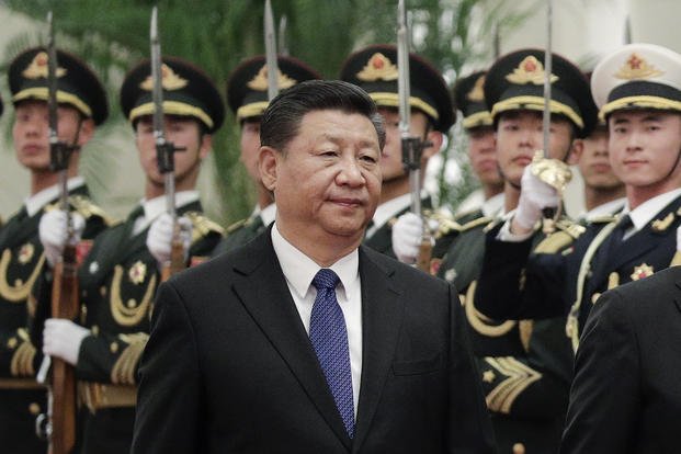 Chinese President Xi Jinping reviews an honor guard at the Great Hall of the People in Beijing