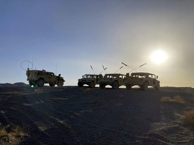 Army vehicles on the ridge at the National Training Center at Fort Irwin, Calif.