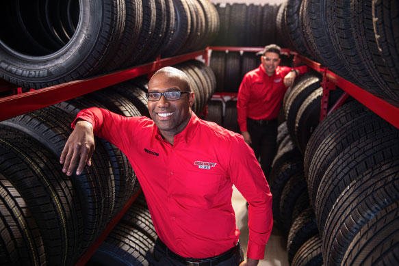Discount Tire employees in tire stock room
