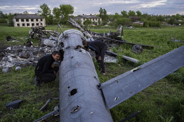 destroyed Russian helicopter lie in a field in the village of Malaya Rohan