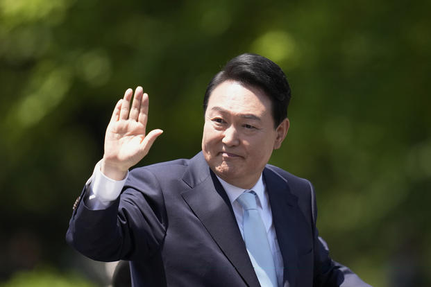 South Korea's new President Yoon Suk Yeol waves