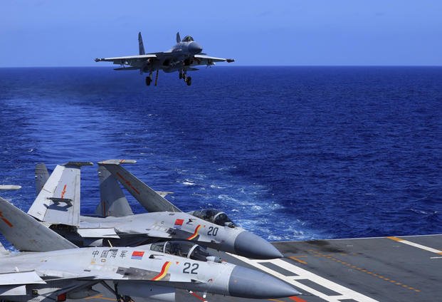 carrier-based J-15 fighter jet preparing to land on the Chinese navy's Liaoning aircraft-carrier