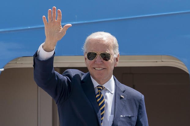 President Joe Biden waves as he boards Air Force One for a trip to South Korea and Japan.