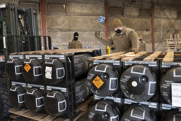Airmen and civilians palletize ammunition, weapons and other equipment bound for Ukraine.