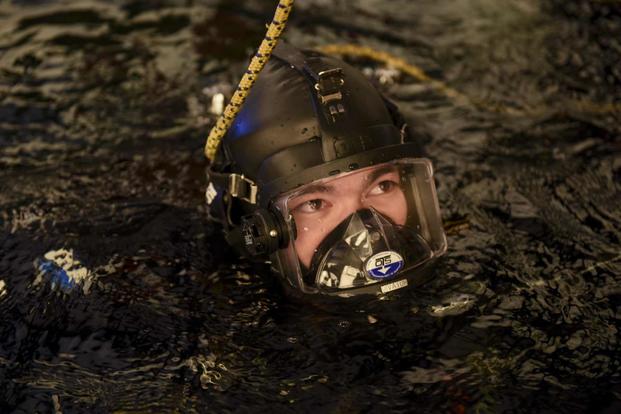 A Coast Guard student in the Cold Water Ice Diving course, treads water.