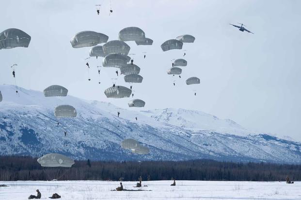 U.S. Army paratroopers jump from a U.S. Air Force C-17in Alaska.