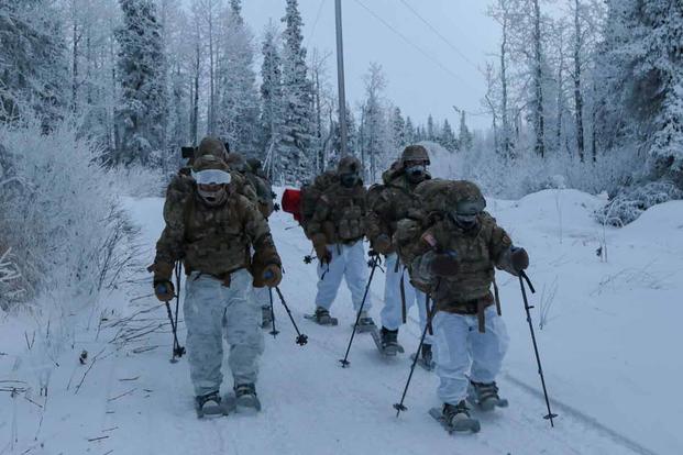 Senior leaders from US Army Alaska travel on snowshoes.