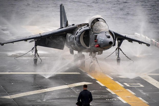 Sailors supervise a ‘wash down’ on the flight deck during the USS Boxer’s first trip after extended maintenance.