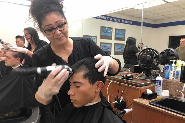 A Space Force Guardian gets his head shaved.