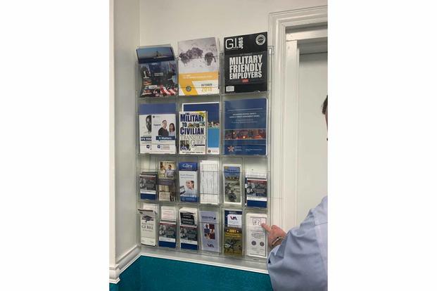 A wall of pamphlets is mounted inside of the House of Prayer.