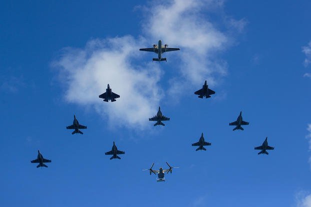 Aircraft fly over the USS Abraham Lincoln (CVN 72) during an air power demonstration.