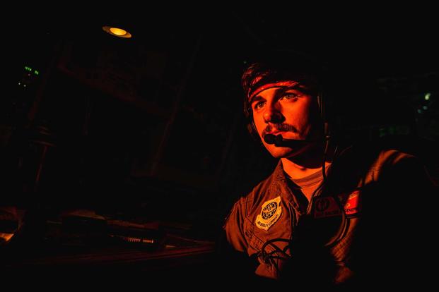 An airman waits to perform air refueling duties.