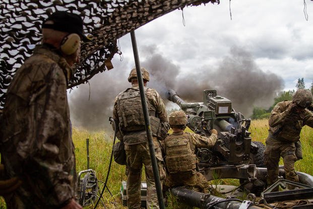 Hilton Labow, a 98-year-old WWII veteran, watches the soldiers of 2nd Battalion, 15th Field Artillery Regiment, 2nd Brigade Combat Team, 10th Mountain Division (LI) as they conduct a live artillery fire exercise.