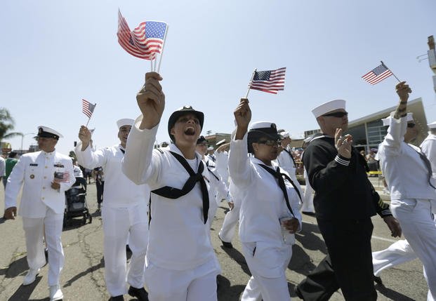 Sailors march in uniform during the gay pride parade in San Diego.