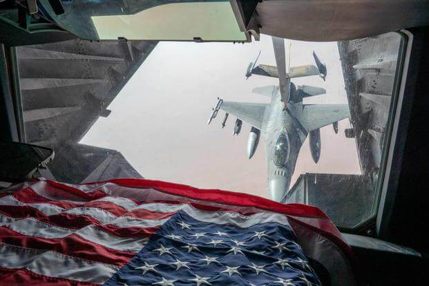 An F-16 receives fuel from a KC-10.