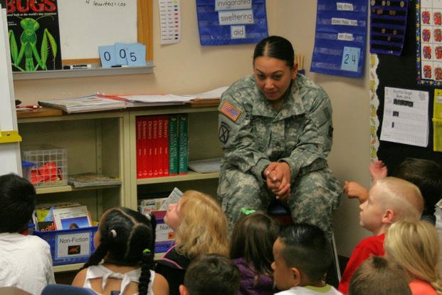 Staff Sgt. Jackie Jones reads to a group of children in their classroom