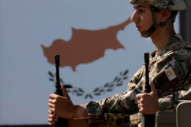 A Cypriot soldier sits on a truck during a military parade in Cyprus.