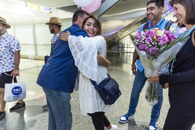 A young Afghan couple hugs during their reunion in Las Vegas. 