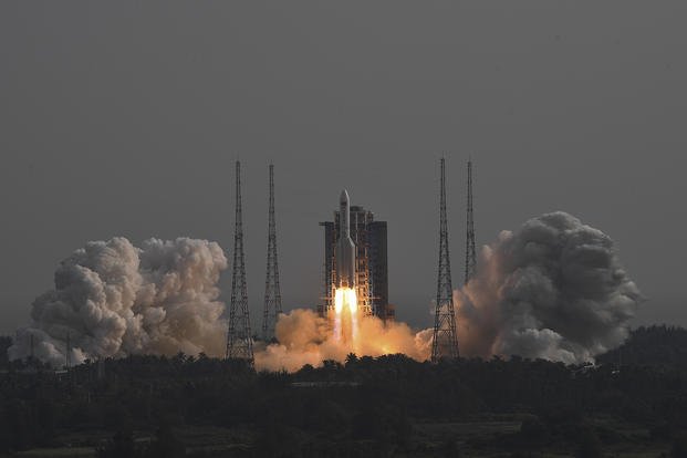 In this photo released by the Xinhua News Agency, the Long March-5B Y4 carrier rocket carrying the space lab module Mengtian blasts off from the Wenchang Satellite Launch Center in south China's Hainan Province.