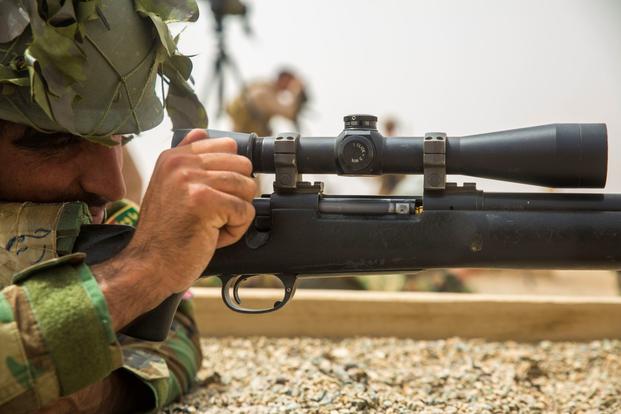 An Afghan National Army soldier loads a round into his weapon.