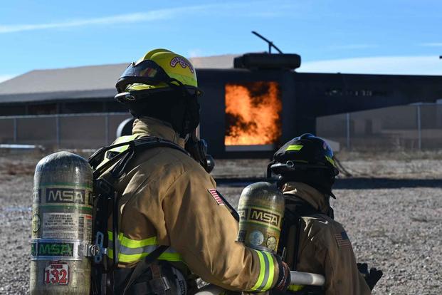 Airmen assigned to Warren Air Force Base in Wyoming fight a simulated fire. (Senior Airman Darius Frazier/U.S. Air Force) Airmen assigned to Warren Air Force Base in Wyoming fight a simulated fire.