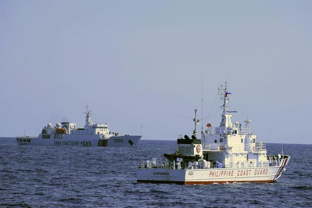 Chinese Coast Guard ship sails near a Philippine Coast Guard vessel
