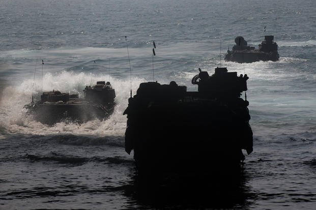 Marines aboard amphibious assault vehicles depart the well deck of amphibious assault ship USS Bataan (LHD 5). 