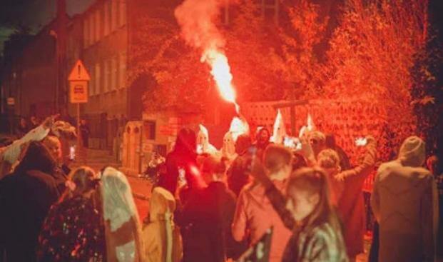 Party-goers kicked the men dressed as klansmen out of the party. 