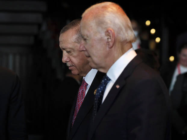 Turkish President Recep Tayyip Erdogan walks with U.S. President Joe Biden. 