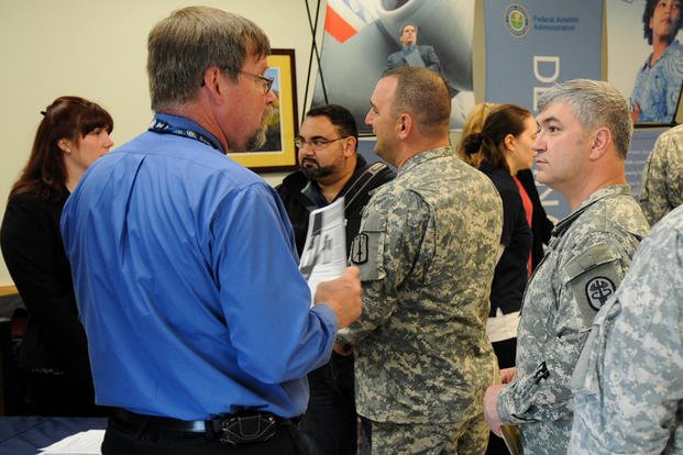 Soldiers assigned to the Warrior Transition Battalion at Joint Base Lewis-McChord, Wash., speak with federal agency representatives during the Operation Warfighter Internship Fair.