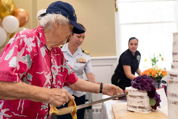 Mary Stewart, a Coast Guard SPAR during World War II, cuts her birthday cake.