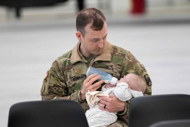 Soldier cares for his baby.
