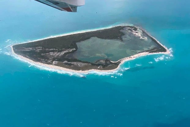 A U.S. Coast Guard C-144 Ocean Sentry circles above Cay Sal Bank in the Bahamas