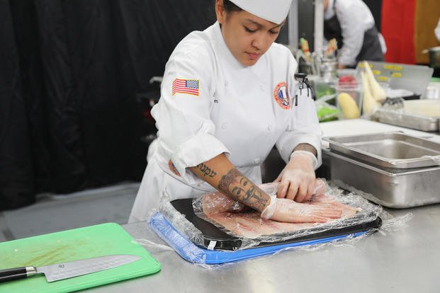 Sgt. Erica Melendres rolls prosciutto around an elk loin during the international team event at the Joint Culinary Training Exercise at Fort Lee, Virginia.