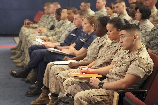 Marines, sailors, soldiers, airmen and Coast Guardsmen listen to military leaders speak during a joint military education seminar at the Henderson Hall portion of Joint Base Myer-Henderson Hall, Virginia.