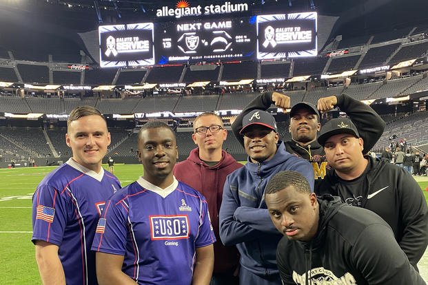 Marine Corps Reserve Sgt. Kolton Lehman, left, is on the field at Allegiant Stadium in Las Vegas with other finalists for the USO/NFL Salute to Service Showdown Madden tournament in November.