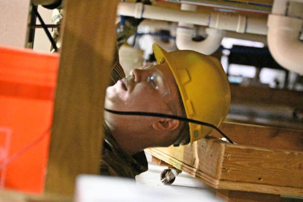A plumber in the National Guard is shown completing the Plumbers Course 003-21 class at the Fort Dix Vertical Skills Training Building, New Jersey.