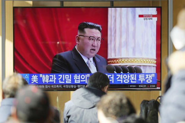 TV shows a news program reporting with footage of North Korean leader Kim Jong Un in Pyongyang