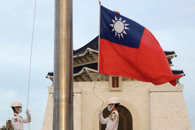 national flag during the daily flag ceremony on Liberty Square of the Chiang Kai-shek Memorial Hall in Taipei