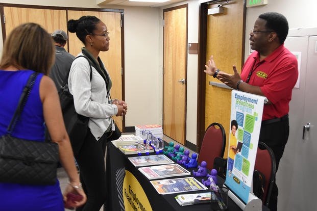 Attendees discuss employment and the job search process with a certified career counselor with the Army Community Service Employment Readiness Program.
