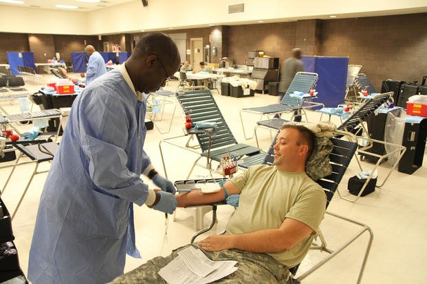 Maj. Golden Hand of the 3rd Medical Command Deployment Support observes Raydale Jordan, a medical technician from the Sullivan Memorial Blood Center on Fort Benning, Ga., preparing the collection of blood. 