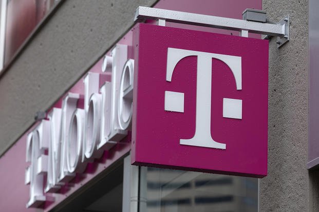 The T-Mobile logo is seen on a storefront in Boston.