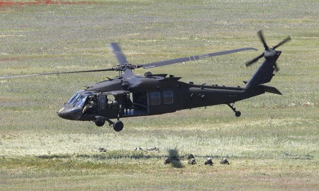 A U.S. Black Hawk helicopter takes off after deploying soldiers during the Swift Response 22 military exercise