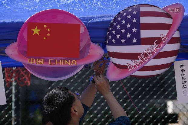booth displaying planets shaped of China and American flags