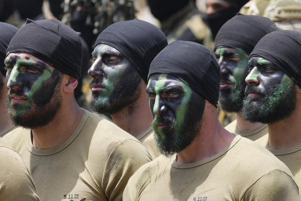 Fighters from the Lebanese militant group Hezbollah carry out a training exercise.