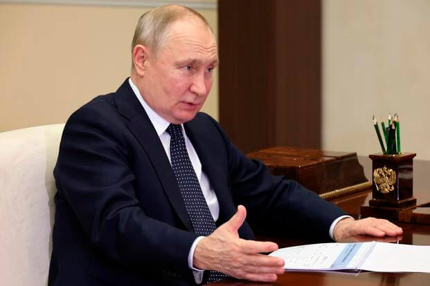 Russian President Vladimir Putin gestures while speaking