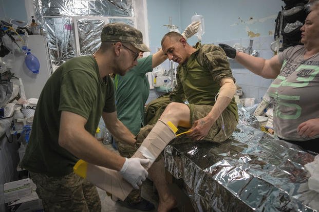 Military medics give first aid to wounded Ukrainian soldiers at a medical stabilization point