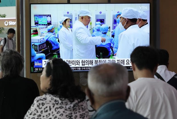 A TV news program shows North Korean leader at the Seoul Railway Station in Seoul, South Korea.