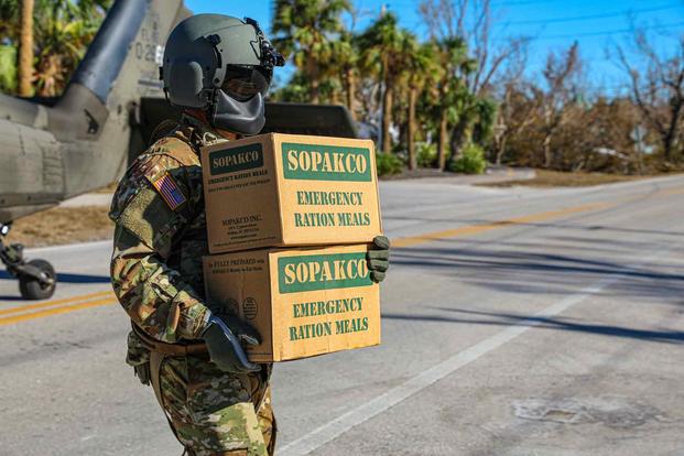 A soldier in the Florida National Guard delivers rations after Hurricane Ian.