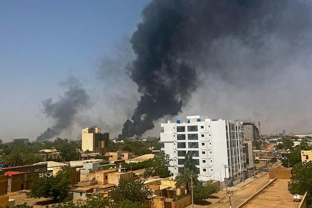 Smoke billows above residential buildings in Khartoum